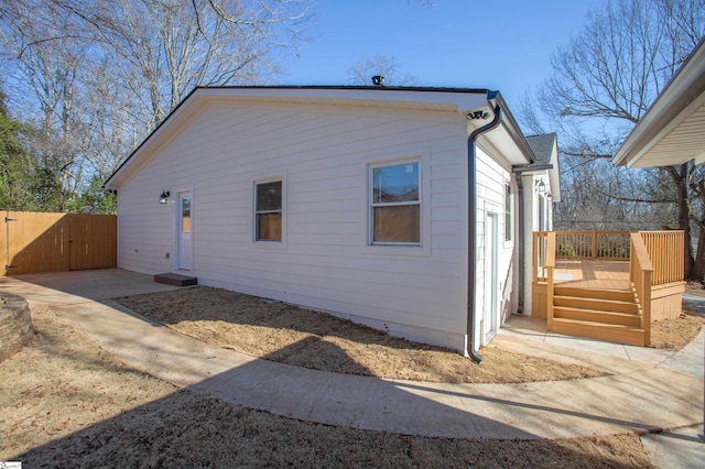 view of side of home with a wooden deck