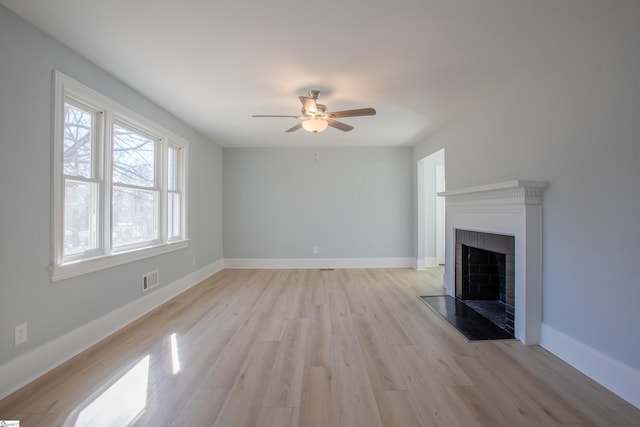 unfurnished living room with ceiling fan and light wood-type flooring