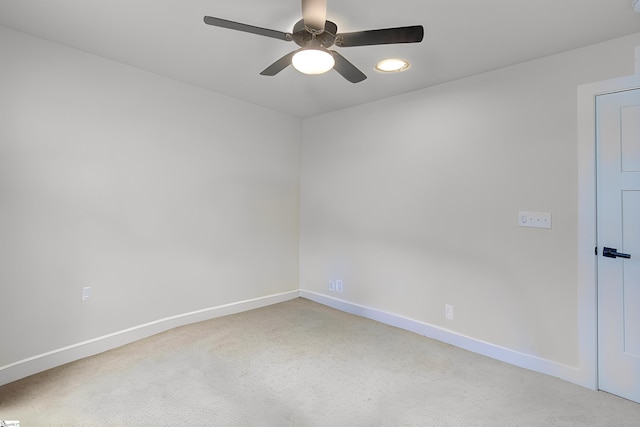 empty room featuring ceiling fan and carpet