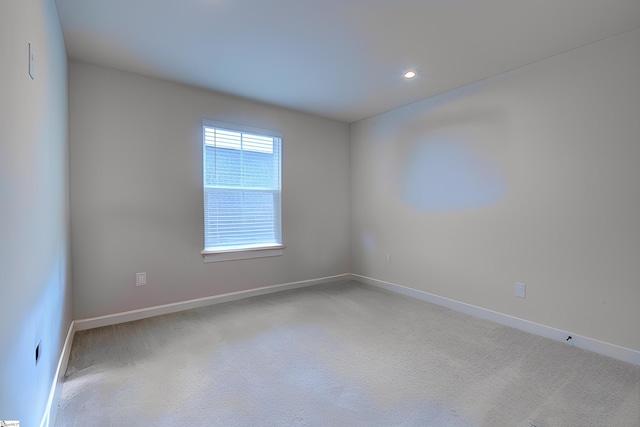 unfurnished room with light colored carpet