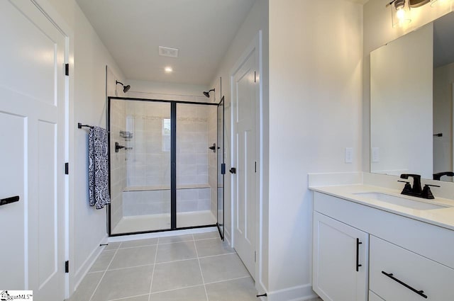 bathroom with tile patterned flooring, vanity, and a shower with shower door