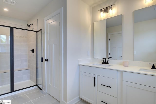 bathroom with tile patterned flooring, vanity, and an enclosed shower