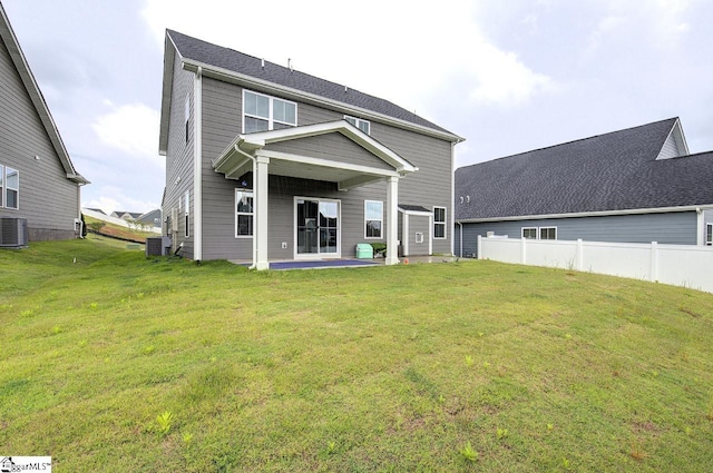 back of property featuring a lawn, central AC unit, and a patio