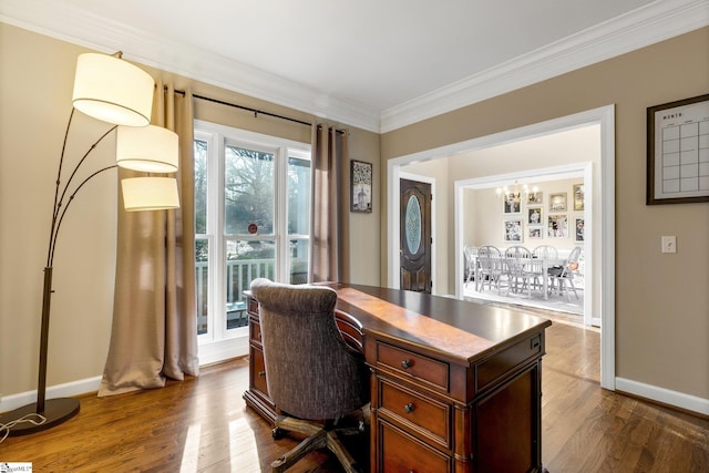 office space featuring hardwood / wood-style floors, crown molding, and a chandelier