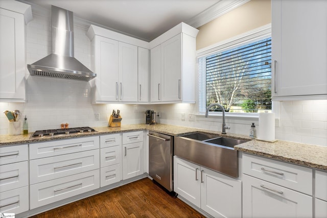 kitchen with white cabinets, wall chimney exhaust hood, backsplash, and appliances with stainless steel finishes