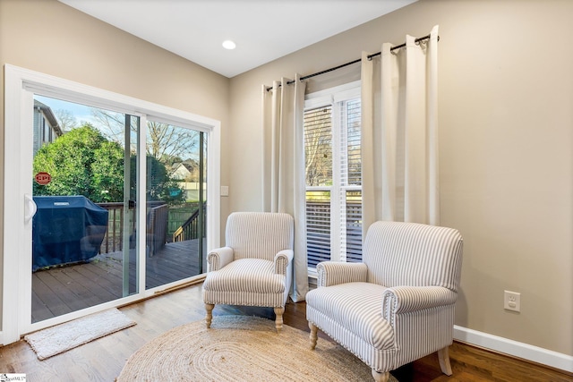 sitting room with a wealth of natural light and hardwood / wood-style flooring