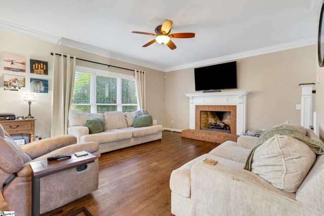 living room featuring a brick fireplace, ceiling fan, dark hardwood / wood-style floors, and ornamental molding