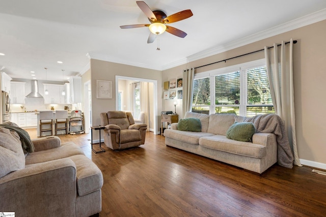 living room featuring ornamental molding, ceiling fan, and dark wood-type flooring