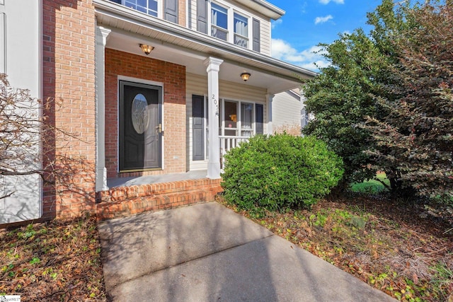 view of exterior entry featuring a porch