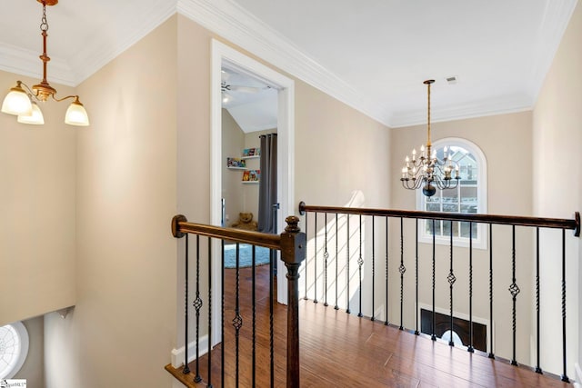 corridor featuring lofted ceiling, crown molding, dark hardwood / wood-style floors, and an inviting chandelier