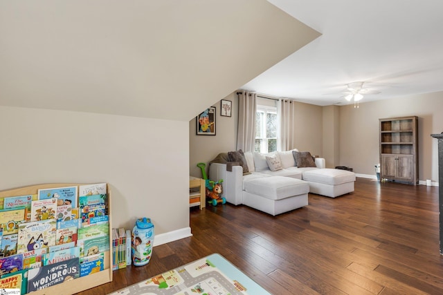 living room with ceiling fan and dark hardwood / wood-style flooring