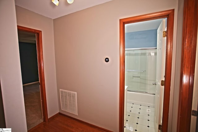 corridor featuring hardwood / wood-style floors