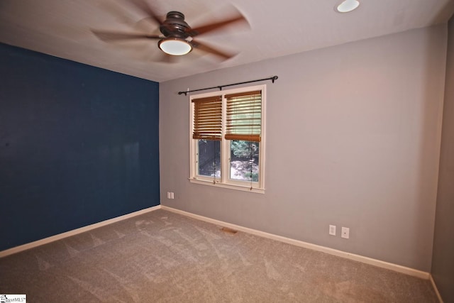 unfurnished room with carpet flooring and ceiling fan