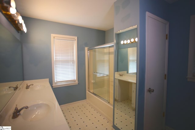 bathroom with vanity and bath / shower combo with glass door