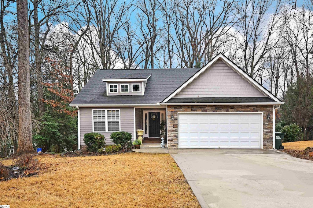 view of front of home with a front lawn and a garage