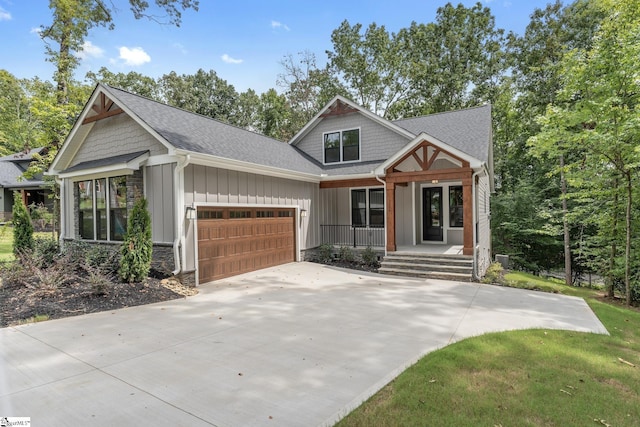 craftsman-style home featuring covered porch and a garage