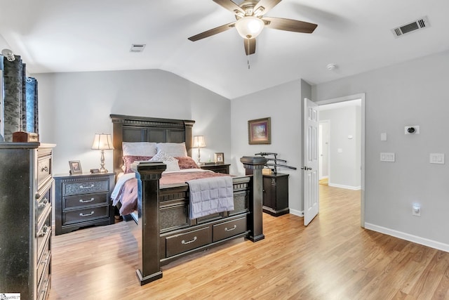 bedroom featuring light wood-type flooring, vaulted ceiling, and ceiling fan