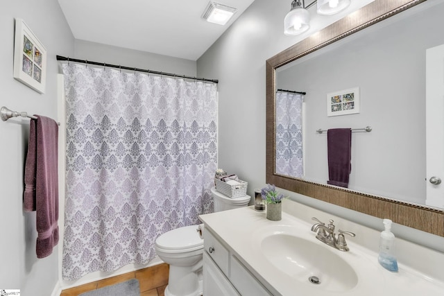 bathroom featuring tile patterned flooring, vanity, and toilet