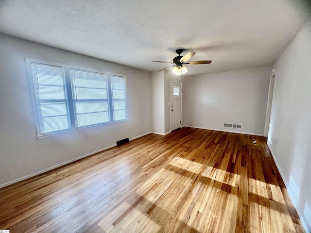 empty room featuring ceiling fan and hardwood / wood-style flooring