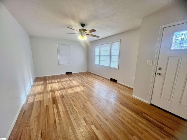 foyer entrance featuring ceiling fan and light wood-type flooring