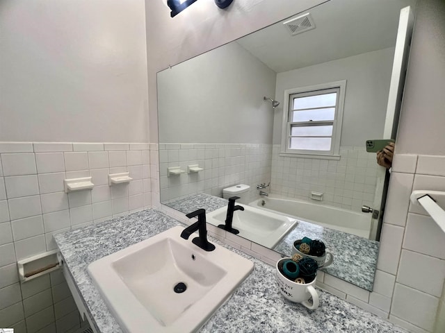 bathroom with sink and tile walls