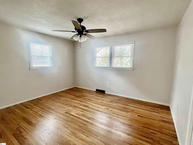 unfurnished room with light hardwood / wood-style floors and ceiling fan