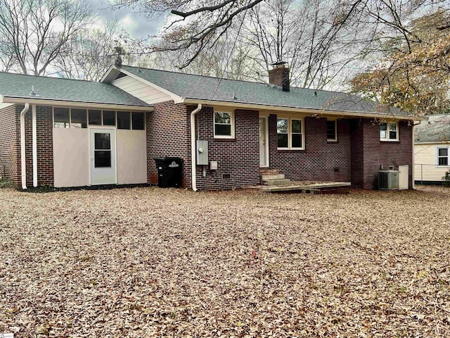 rear view of property with a sunroom and central AC unit