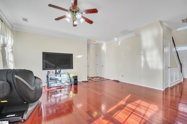 living area with ceiling fan, ornamental molding, wood-type flooring, and visible vents