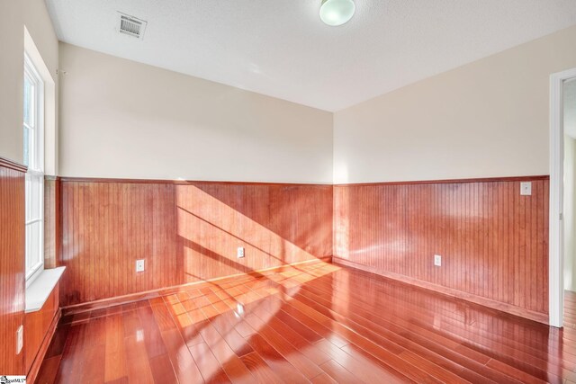 unfurnished room with wood-type flooring