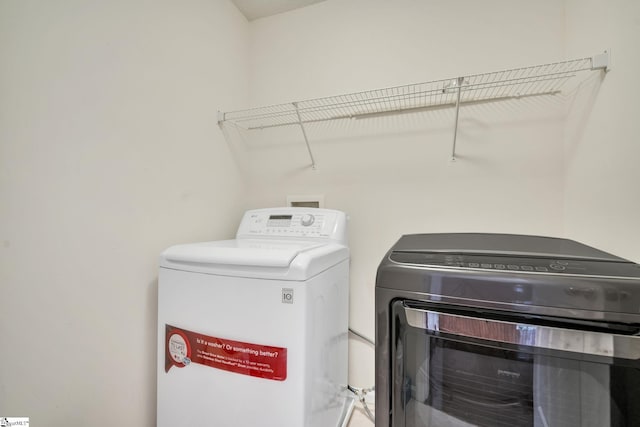 laundry area with separate washer and dryer