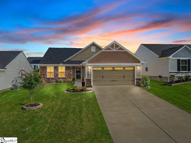 craftsman inspired home with a lawn and a garage