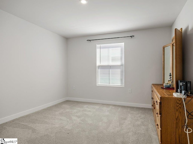 unfurnished room with light carpet