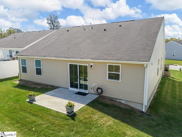 back of house featuring a patio area and a yard