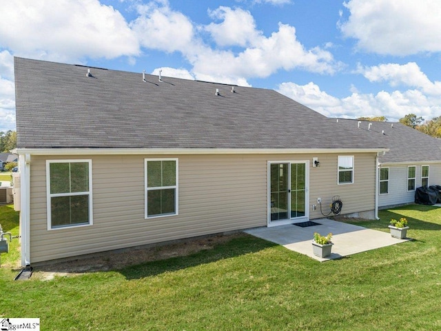 rear view of property with central AC unit, a yard, and a patio