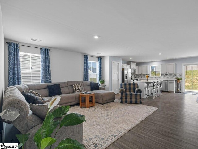 living room with dark hardwood / wood-style flooring