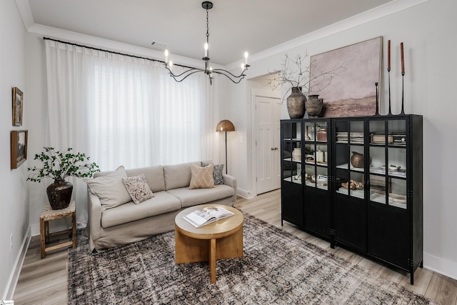 living room featuring crown molding and light hardwood / wood-style flooring