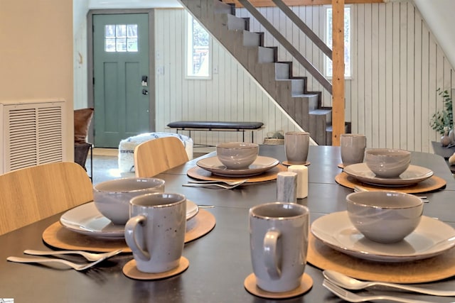 dining space featuring wooden walls