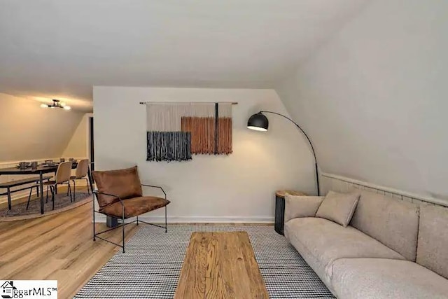 living room featuring light hardwood / wood-style floors and lofted ceiling