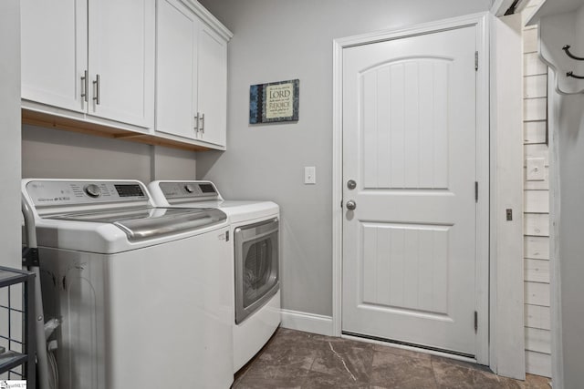 laundry room with washer and dryer and cabinets