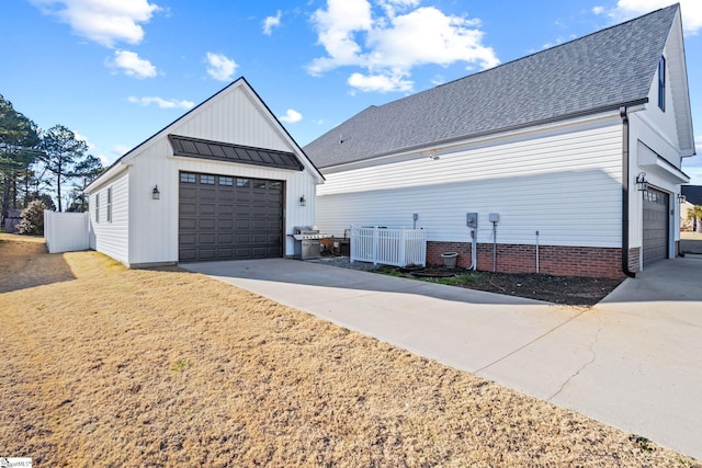 view of side of home featuring central AC, an outbuilding, and a garage