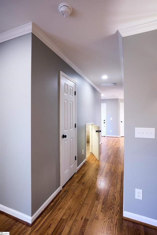 hallway featuring hardwood / wood-style flooring and ornamental molding