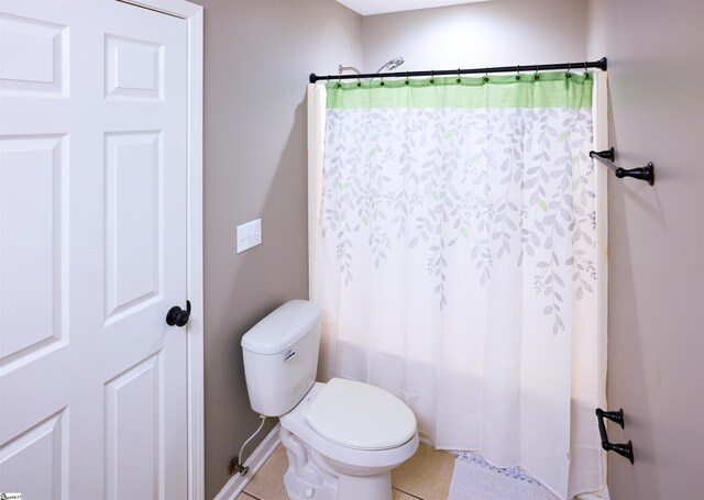 bathroom featuring toilet, tile patterned flooring, and walk in shower