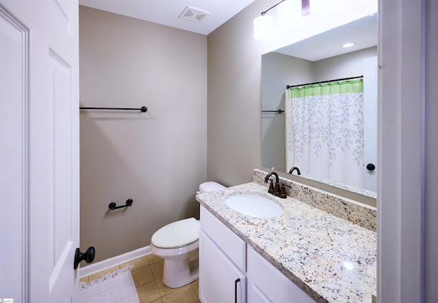 bathroom with tile patterned floors, vanity, and toilet