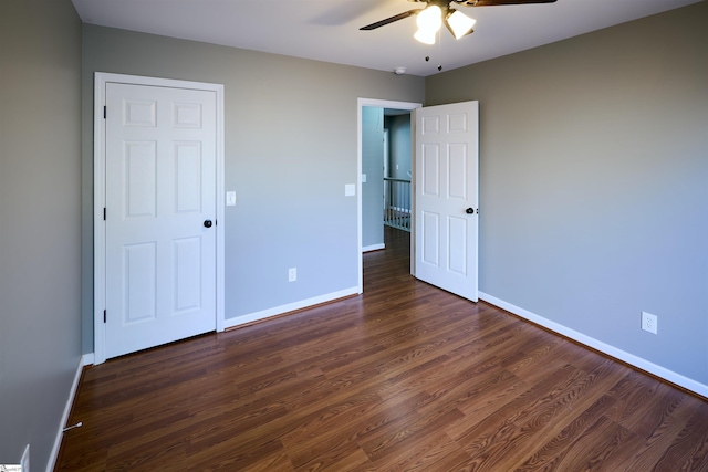 unfurnished bedroom featuring dark hardwood / wood-style flooring and ceiling fan