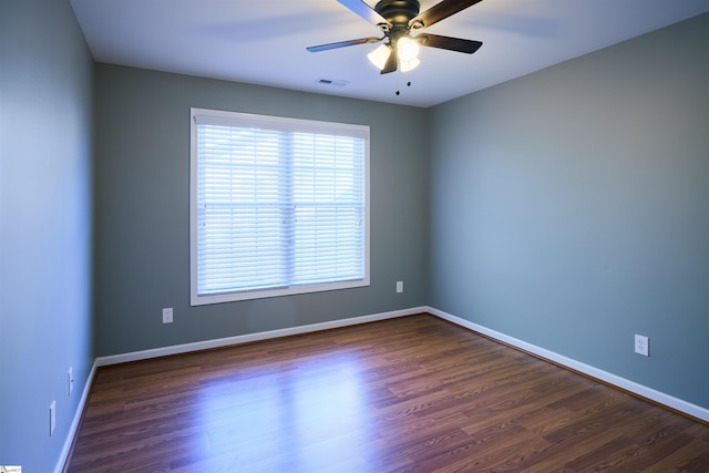 empty room with ceiling fan and dark hardwood / wood-style floors