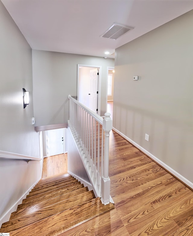 stairs with wood-type flooring