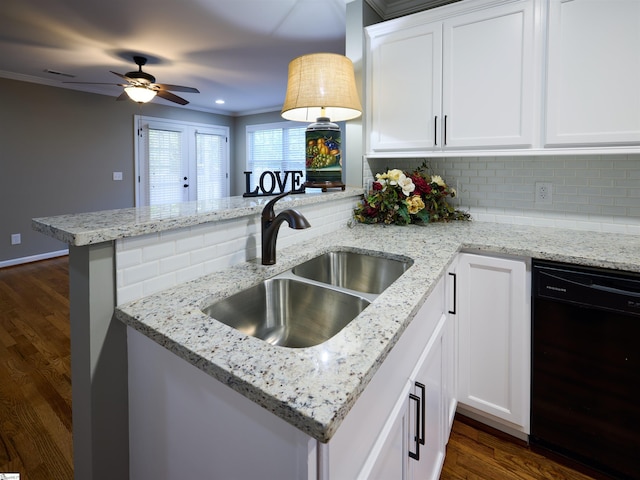 kitchen featuring backsplash, white cabinets, sink, black dishwasher, and kitchen peninsula