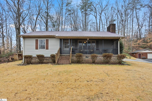 view of front of property with a front yard and a sunroom