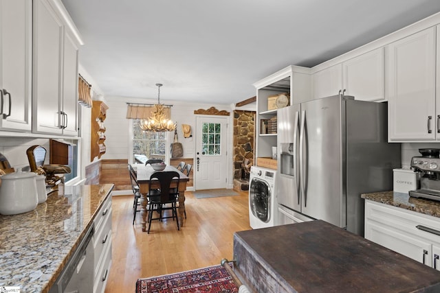 kitchen featuring washer / clothes dryer, white cabinetry, and appliances with stainless steel finishes