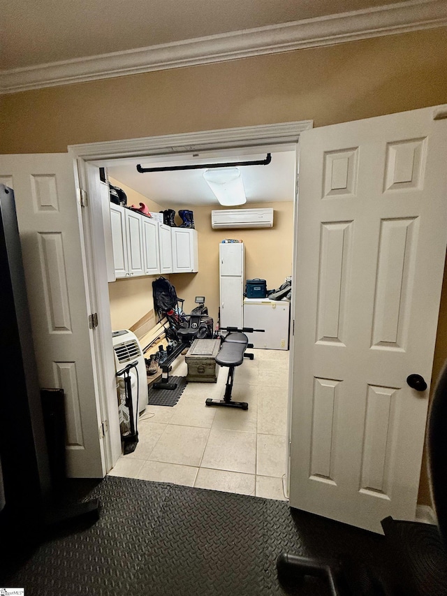 workout room with a wall mounted air conditioner, light tile patterned floors, and ornamental molding